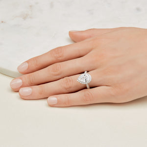 Large diamond engagement ring on hand.
