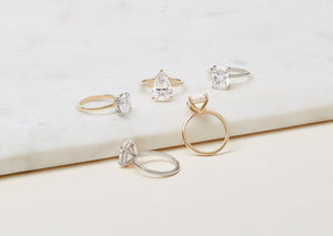 Collection of five diamond solitaire engagement rings