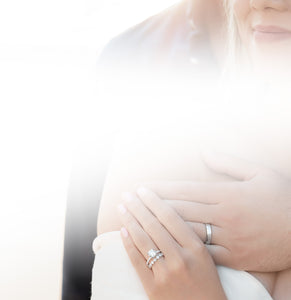 Engaged couple featuring engagement rings