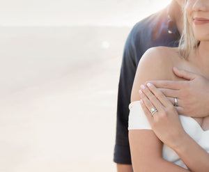 Engaged couple featuring engagement rings